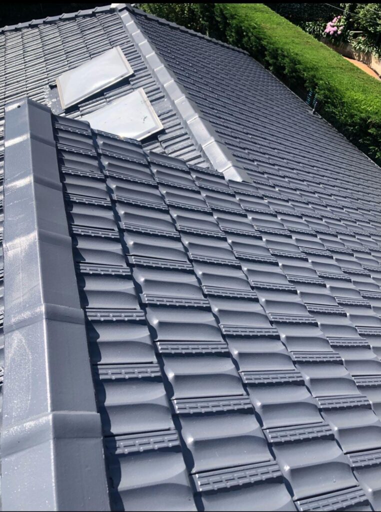 Close-up of high-gloss charcoal roof tile painting finish with integrated skylights