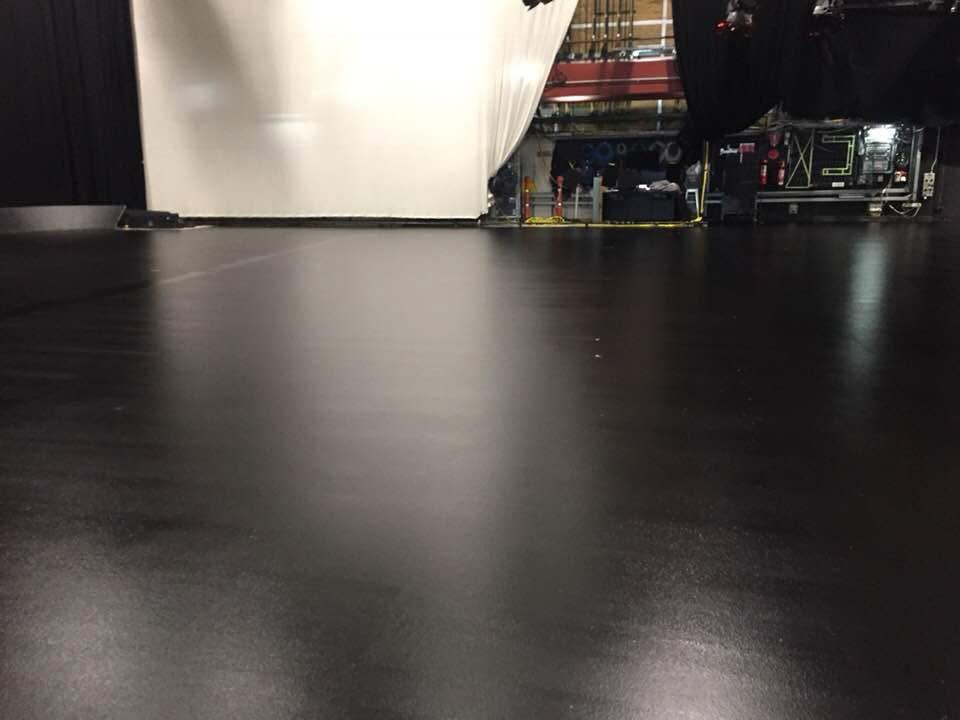 Close-up view of a smooth, durable black industrial floor coating showing a seamless professional finish.